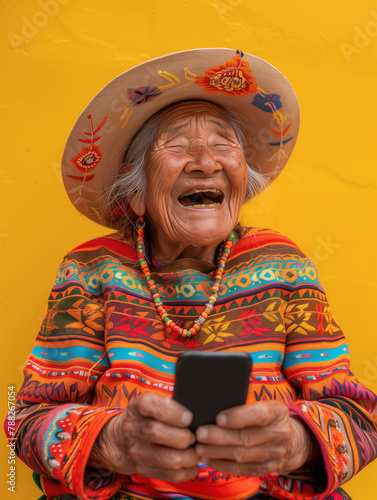 Old woman from Bolivia, laughing out loud at something she has seen on a phone. Image bringing joy.