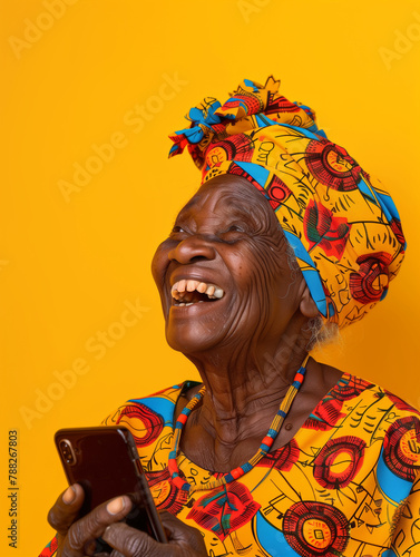 Old woman from West Africa, laughing out loud at something she has seen on a phone. Image bringing joy.