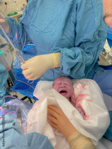 A portrait of a new born baby boy. This photo was captured only minutes after being born by a Caesarean Section at hospital.