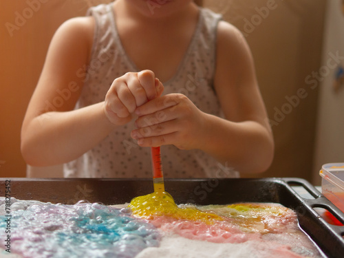 a child makes experiments with chemicals. experiments with soda and citric acid