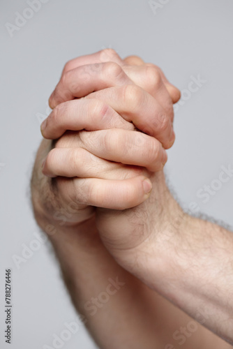 фотографія Closeup studio shot of hands on unrecognizable man with interlocked fingers