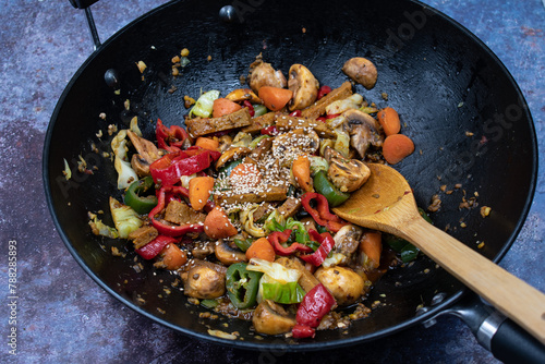 Vegan stir fry in wok- seitan and mixed veggies