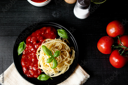 Spaghetti with tomato sauce. on a black background. dinner