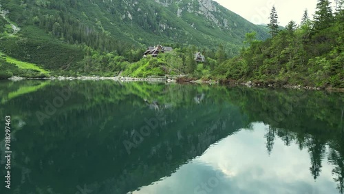 Amazing Lake in the High Mountains. Aerial drone video flying over the turquoise lake, Wooden house background mountains. Famous Mountains Lake Morskie Oko, Sea Eye in Tatry Mountains Tatras Zakopane (ID: 788297463)