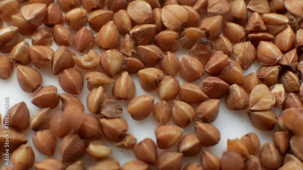 Healthy Eating. organic food buckwheat grains are piled close-up. macro shooting. shooting food brown grains close-up. nice background for a diet video. nutrition for wellness Healthy Eating. organic food buckwheat grains are piled close-up. macro shooting. shooting food brown grains close-up. nice background for a diet video. nutrition for wellness
