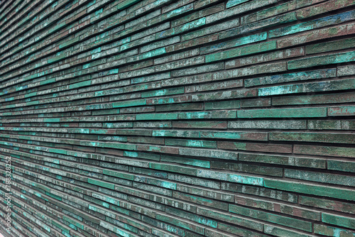 Texture of decorative green brick wall. House facade. Wall in the loft.