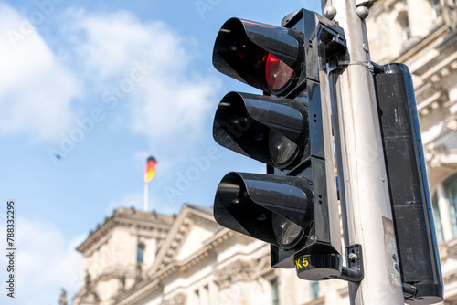 Fototapeta Naklejka Na Ścianę i Meble -  Road traffic light against the backdrop of the Reichstag. Traffic light close-up.