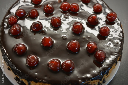 Food, Finnish cuisine, desserts. A very tasty sponge cake made with buttercream, chocolate frosting and red cherries.