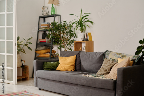 фотографія Part of spacious living room of modern apartment with comfortable couch with cus