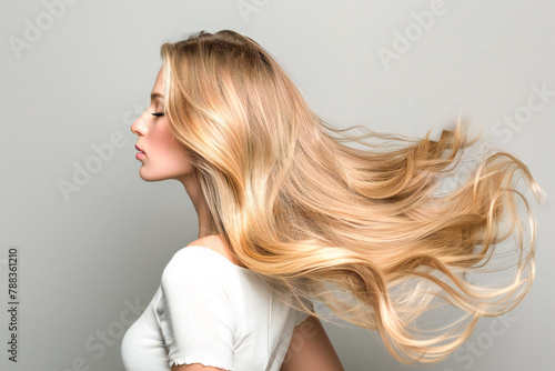 Beautiful blonde girl hair after hair coloring in the salon, shiny locks of hair and new hairstyle 