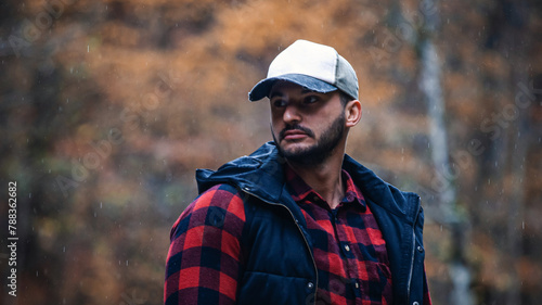 Portrait of Handsome Young Man with Cap and Checkered Shirt in Foggy Autumn Forest
