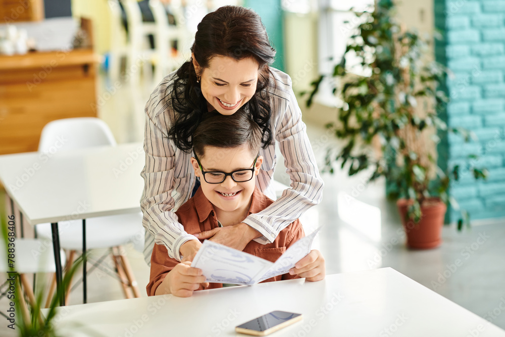 joyful good looking mother in casual clothes with her inclusive son with Down syndrome holding menu joyful good looking mother in casual clothes with her inclusive son with Down syndrome holding menu