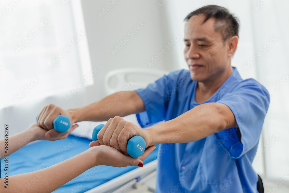 Obraz premium Physical therapy assistance Asian female doctor with senior man in physical therapy rehabilitation or health support Female physical therapist or physical therapist counseling an elderly patient.