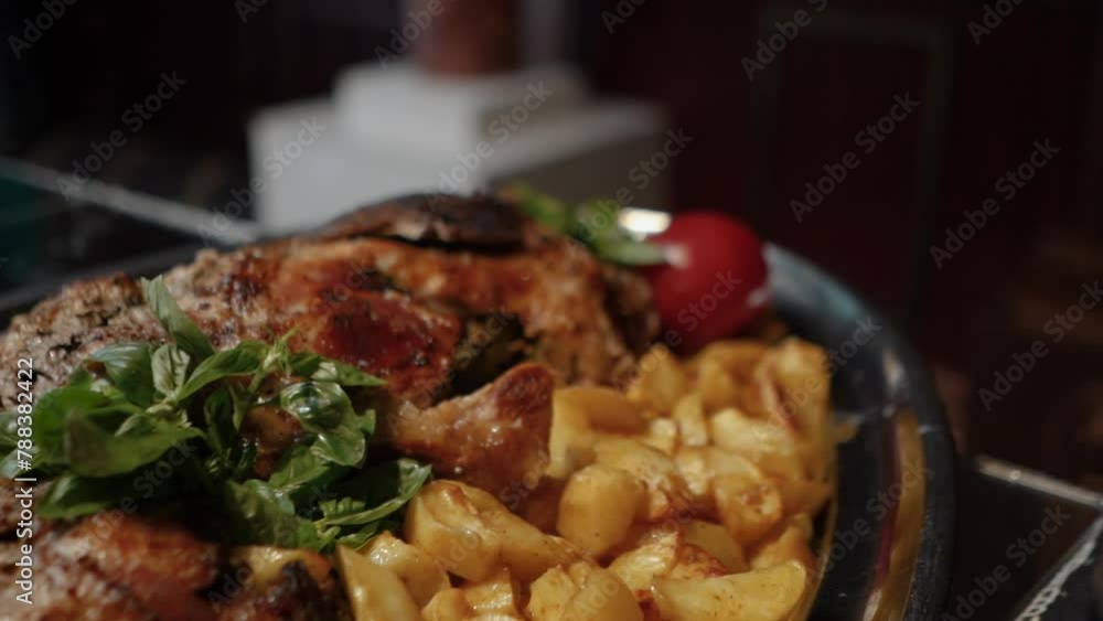 delicious aromatic fried potatoes with grilled meat steak, with herbs and red tomatoes at a banquet during a celebration delicious aromatic fried potatoes with grilled meat steak, with herbs and red tomatoes at a banquet during a celebration