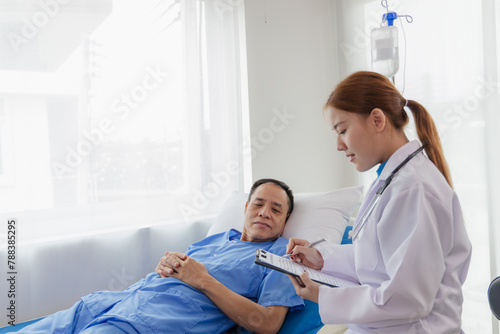 Young Asian female doctor talking with elderly man Provide care and assistance to patients in hospital beds Elderly health care and medicine