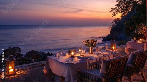 Romantic beach dinner setup at sunset, perfect for travel and dining experiences.