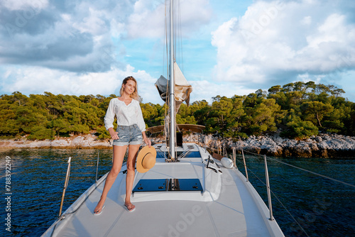 Luxury travel on the yacht. Young happy woman on boat deck sailing the sea. Yachting in sea. © luengo_ua