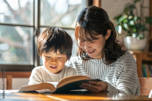 A Japanese mother and child enjoy reading a book together while completing homework, their excitement from learning evident.