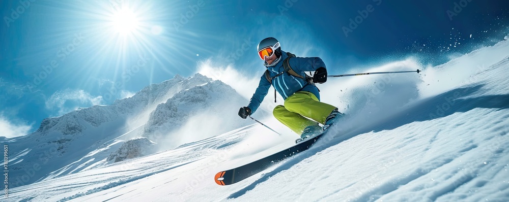Skilled skier skiing down on a slope against blue sky and mountains Skilled skier skiing down on a slope against blue sky and mountains