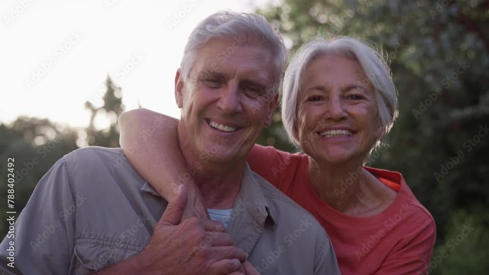 Portrait loving senior couple laughing and smiling hugging outdoors in garden or countryside with lens flare - shot in slow motion Portrait loving senior couple laughing and smiling hugging outdoors in garden or countryside with lens flare - shot in slow motion