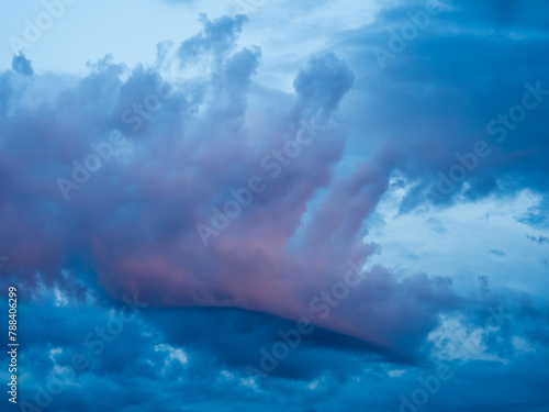 Bizarre colored storm clouds in blue sky