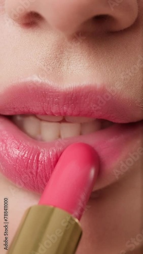 close-up of lips in the process of applying lipstick. Macro (ID: 788411000)