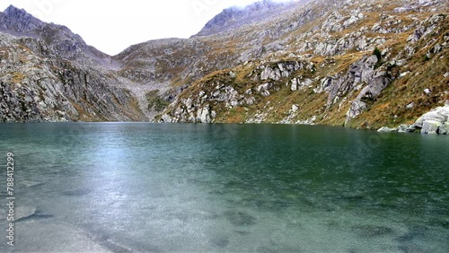 Spectacular alpine landscape with rain on the Dolomite lake of Lambin. photo