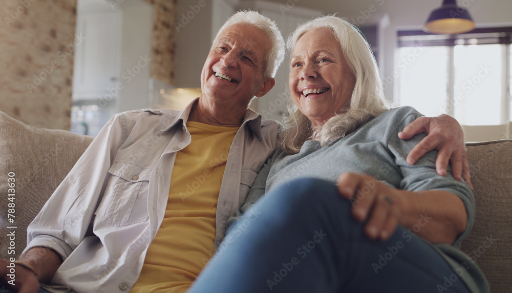 Obraz premium Happy, senior couple and watching tv in living room, home and house on sofa in retirement together. Partners, elderly people and relax with smile on couch for comedy, live streaming and funny video