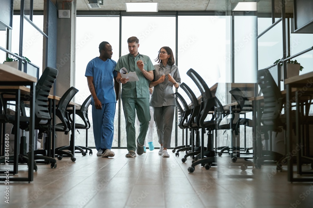 Walking together. Group of doctors are indoors