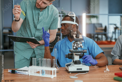 Two male doctors are working indoors together