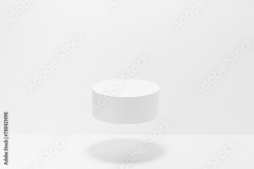 One round white pedestal mockup for cosmetic products, levitate in hard light, shadow on white background. Scene for presentation skin care products, gifts, advertising, sale, goods in elegant style.