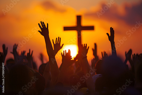 Christian worshipers raising hands up in the air in front of the cross © zunaira