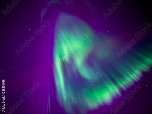 Aurora Borealis in a spiralling in the sky at Santa Claus Village Rovaniemi