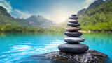 Stack of zen stones on blue water background. Spa, Zen concept.