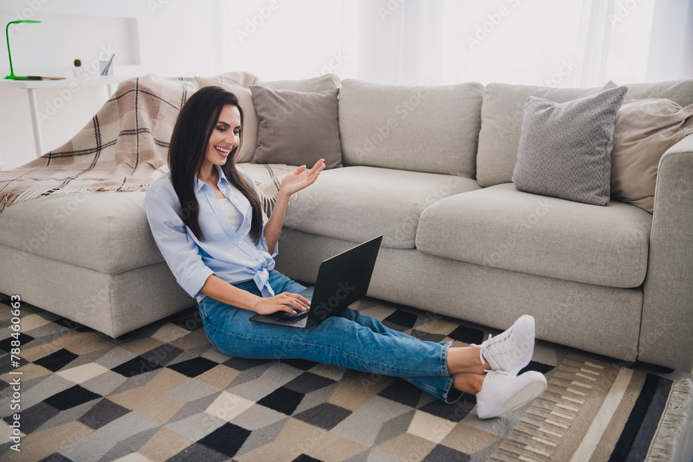 Full size photo of nice lady speak video call laptop wear blue shirt bright interior flat indoors Full size photo of nice lady speak video call laptop wear blue shirt bright interior flat indoors
