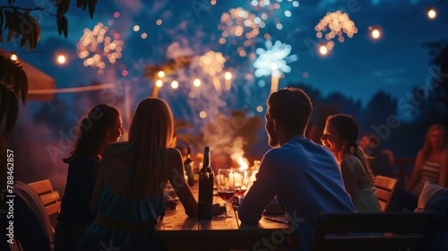 A group of friends watching fireworks and enjoying the night sky on Independence Day. 