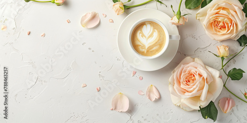 Artful cappuccino coffee with a frothy heart surrounded by pastel pink roses, speaks to love and tenderness