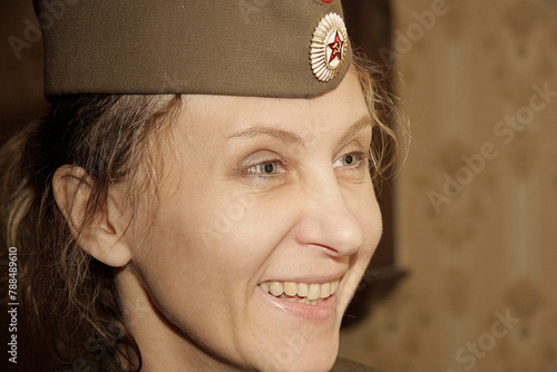 Close-up portrait of a woman in a military cap. Close-up, retro portrait. Vintage historical portrait.