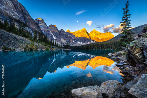 Alpine lake in mountains at sunrise. Moraine Lake in Banff National Park, Canadian Rockies, Alberta, Canada.