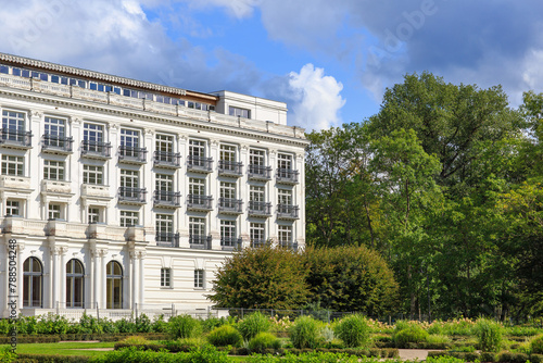white hotel building in a summer park
