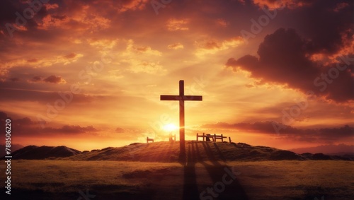 A wooden cross on a hill at sunset