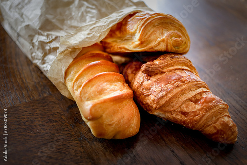 variety of ffreshly baked rench viennoiseries on wooden surface photo