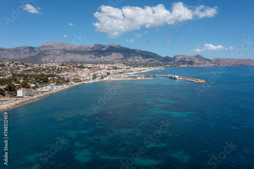 Fototapeta Naklejka Na Ścianę i Meble -  Aerial drone photo of the Spanish town of L'Albir in Spain Alicante showing the beach front on a sunny summers day with the Spanish mountains in the background