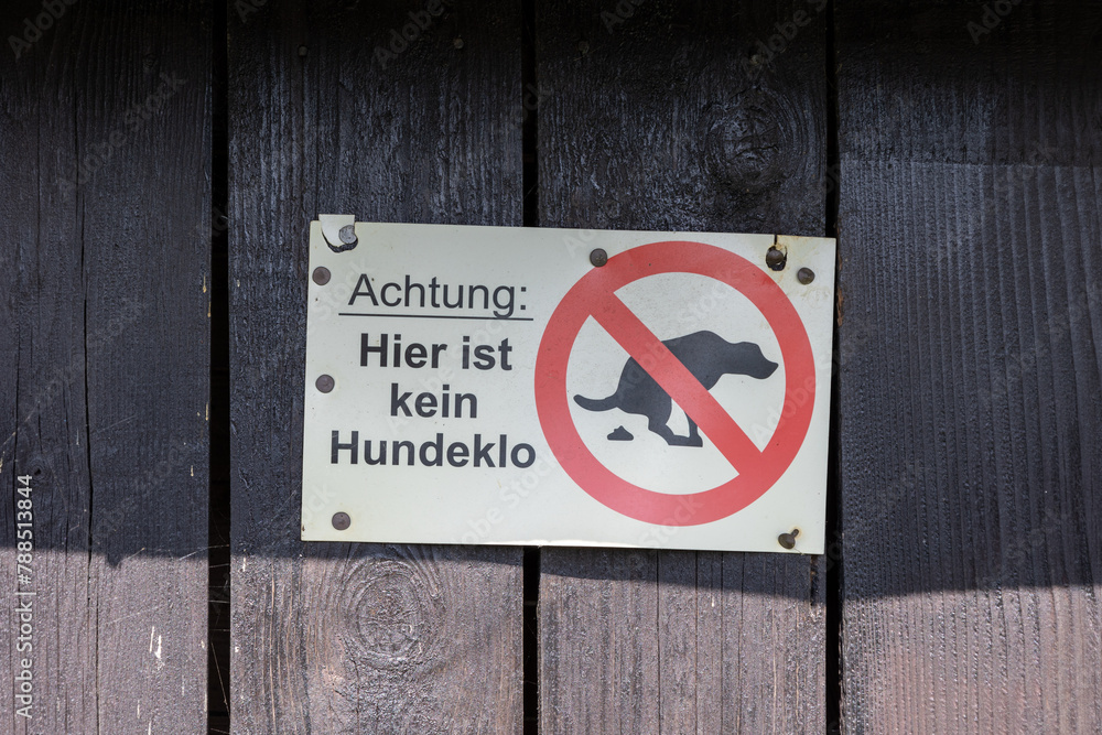 No dog fouling sign on wooden park fence No dog fouling sign on wooden park fence