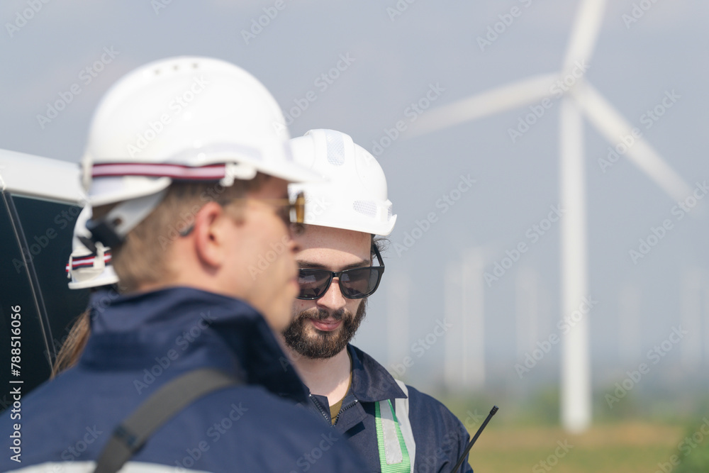Wind farm engineers conducting a field assessment for turbine maintenance operations. Wind farm engineers conducting a field assessment for turbine maintenance operations.