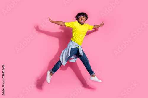 Photo of cheerful optimistic man wear stylish yellow clothes jump up good mood fly air isolated on pink color background