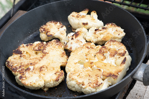Grilled or roasted cauliflower in a pan as a healthy alternative to meat