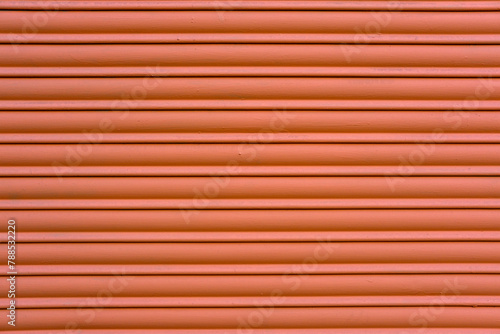 Background from a red painted roller shutter of a shop