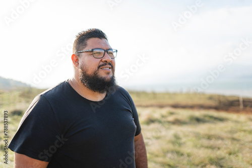 Portrait of a smiling plus-size man outdoors