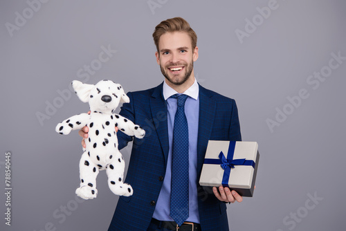 Mens day. Successful boss share gift box. Businessman prepare for romance date. Business reward. Business man with corporate gift box isolated on grey. Corporate present. Valentines day